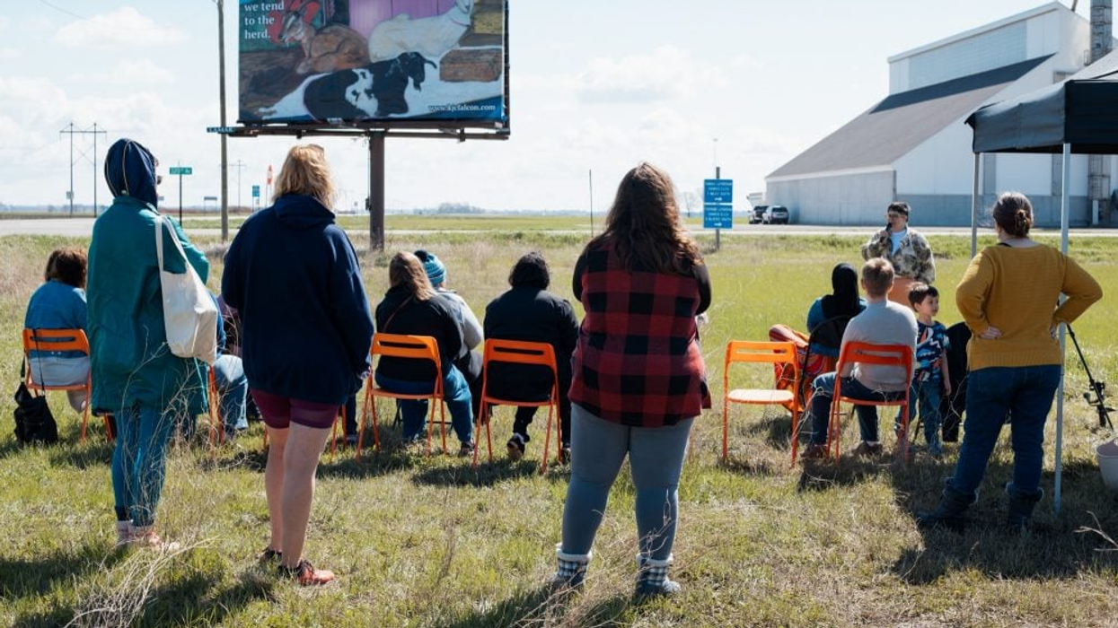 Kandace Creel Falcón gives talk on billboard of goats.