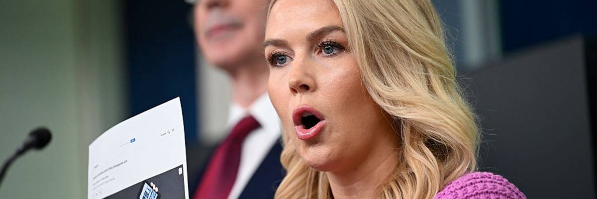 Karoline Leavitt holds a photo of Jeff Bezos