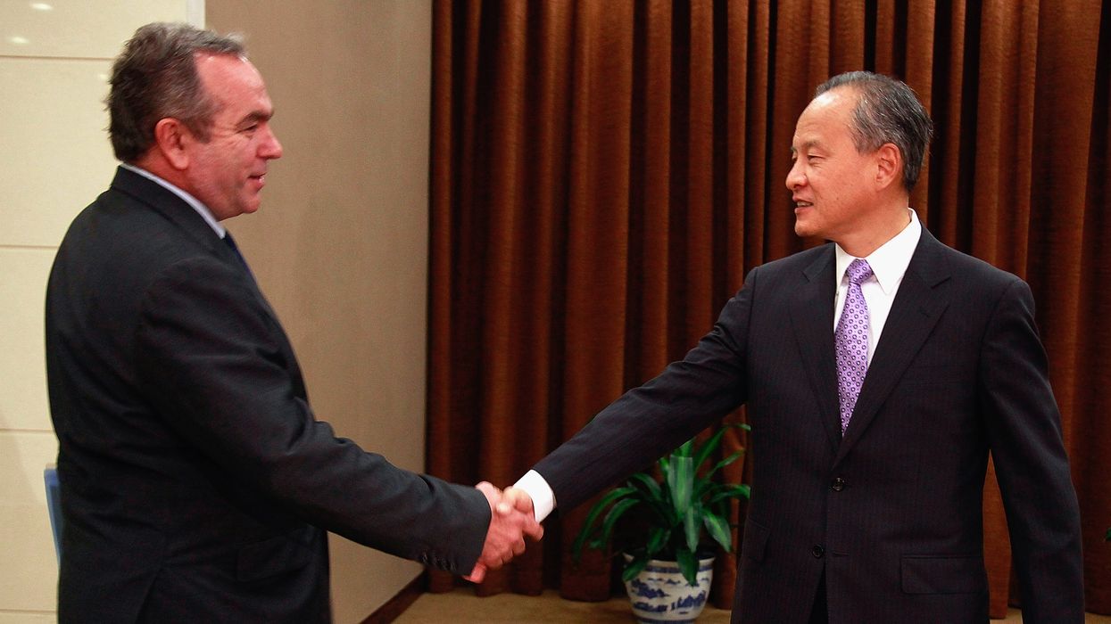Kurt Campbell and Cui Tiankai shake hands.