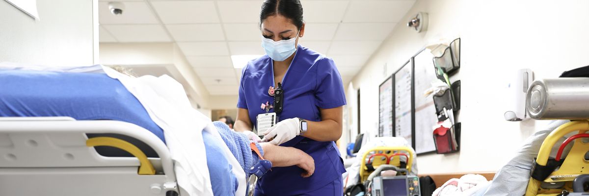 Lab technician Alejandra Sanchez cares for a patient in the emergency department at Providence St. Mary Medical Center on March 11, 2022 in Apple Valley, California.