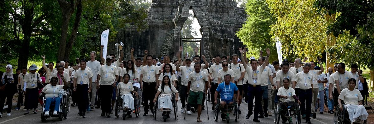 Landmine victims and government officials take part in a march