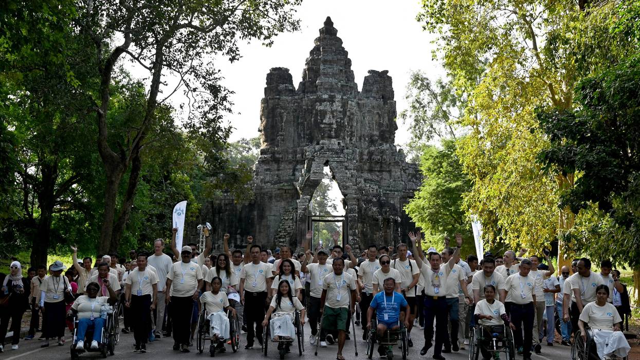 Landmine victims and government officials take part in a march