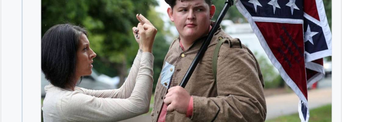 Lara Rogers confronts Allen Armentrout, holding a Confederate flag in Charlottesville in 2017 days after white supremacists marched there. Armentrout was "defending" a statue pf Robert E. Lee, who he called "the greatest American that ever lived."