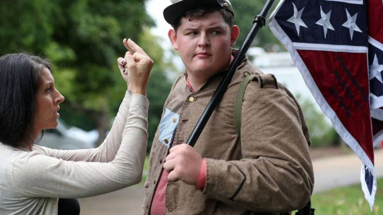 Lara Rogers confronts Allen Armentrout, holding a Confederate flag in Charlottesville in 2017 days after white supremacists marched there. Armentrout was "defending" a statue pf Robert E. Lee, who he called "the greatest American that ever lived."