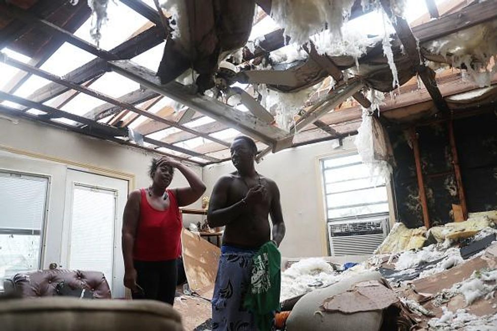 Latasha Myles and Howard Anderson stand in their living room where they were sitting when the roof blew off around 2:30am as Hurricane Laura passed through the area on August 27, 2020 in Lake Charles, Louisiana . The hurricane hit with powerful winds causing extensive damage to the city. (Photo: Joe Raedle/Getty Images)