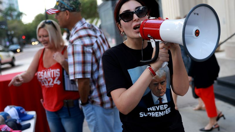Laura Loomer speaks into a megaphone.