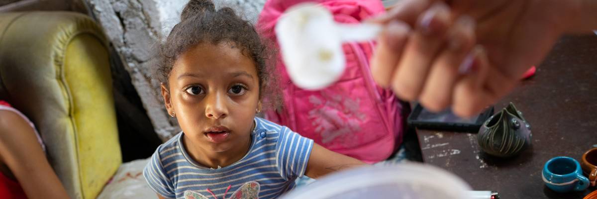 Laurent Alemany, 4, looks at the small amount of powdered milk her mother, Yohana Perdomo, 28, has left in their home in Havana, Cuba on April 16, 2022.