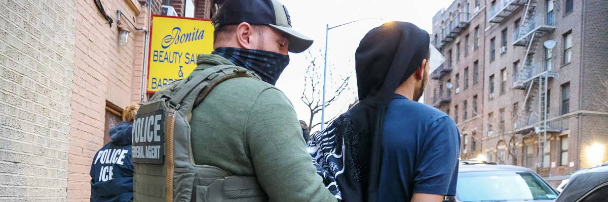 Law enforcement and immigration agents arrest a man