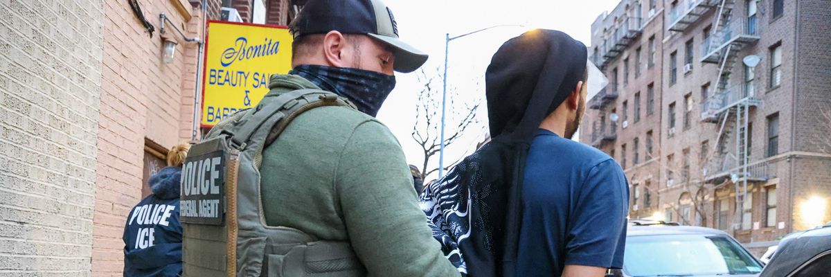 Law enforcement and immigration agents arrest a man