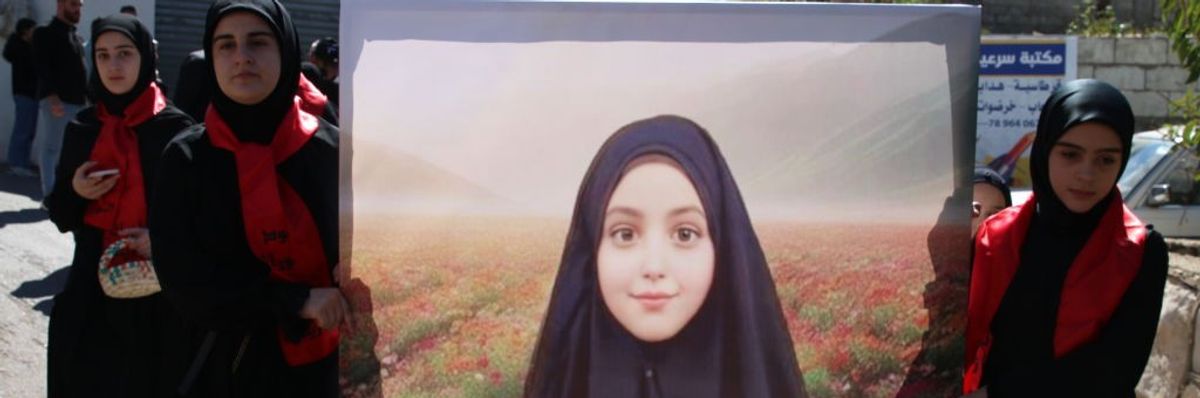 Lebanese women mourn the death of 9-year-old Fatima Abdullah
