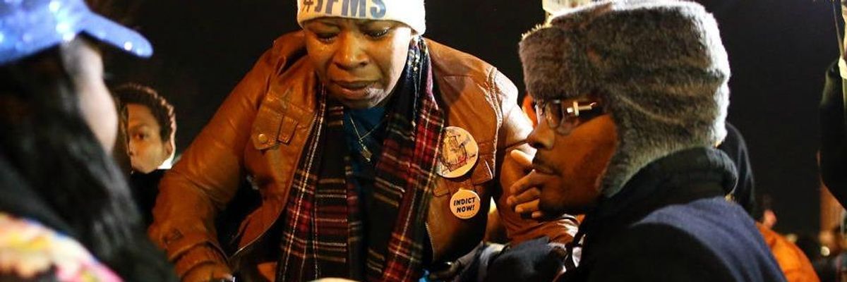 Lesley McSpadden, mother of Michael Brown, is escorted away from in front of the Ferguson police department after a grand jury's decision was delivered on November 24, 2014 in Ferguson, Missouri