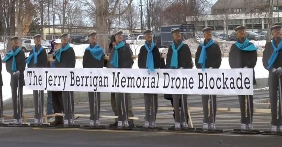 Life-size cut-outs of Jerry Berrigan arrayed to blockade at Hancock airbase in upstate New York on Jan. 28, 2016. (Screen grab from YouTube video)