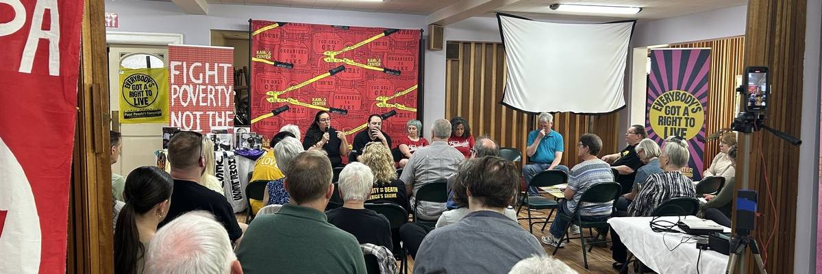 Liz Theoharis and Noam Sandweiss-Back speak with a crows in a Pennsylvania church.