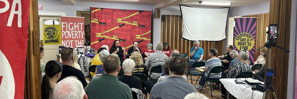 Liz Theoharis and Noam Sandweiss-Back speak with a crows in a Pennsylvania church.