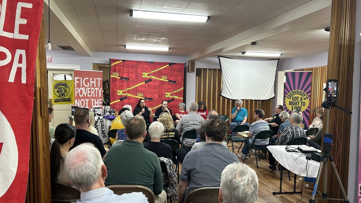 Liz Theoharis and Noam Sandweiss-Back speak with a crows in a Pennsylvania church.