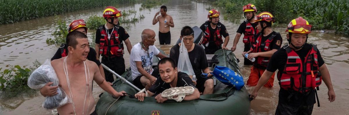 Local residents escape flood waters by boat in Hebei Province, China