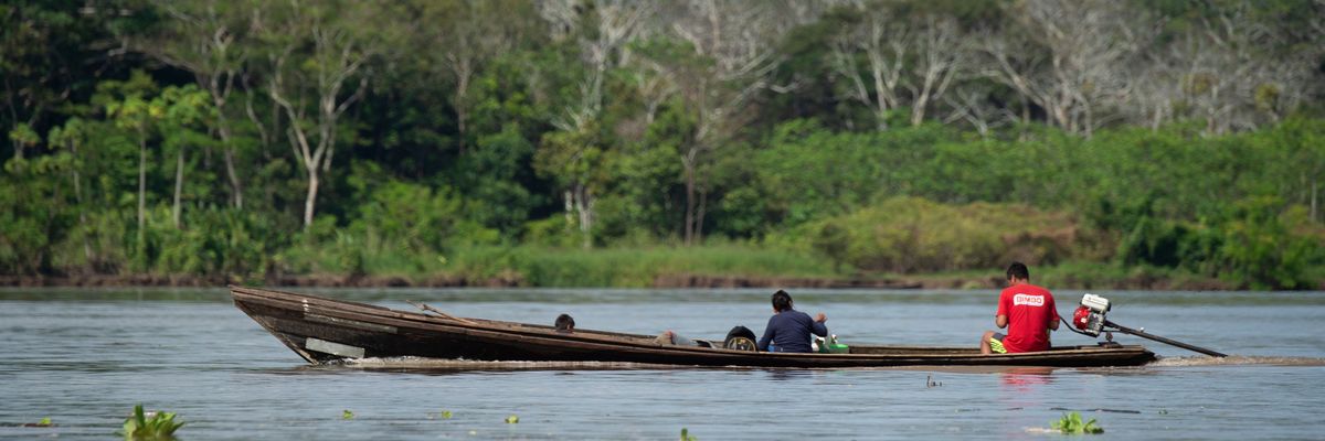 Locals ride a boat on the Marañón River