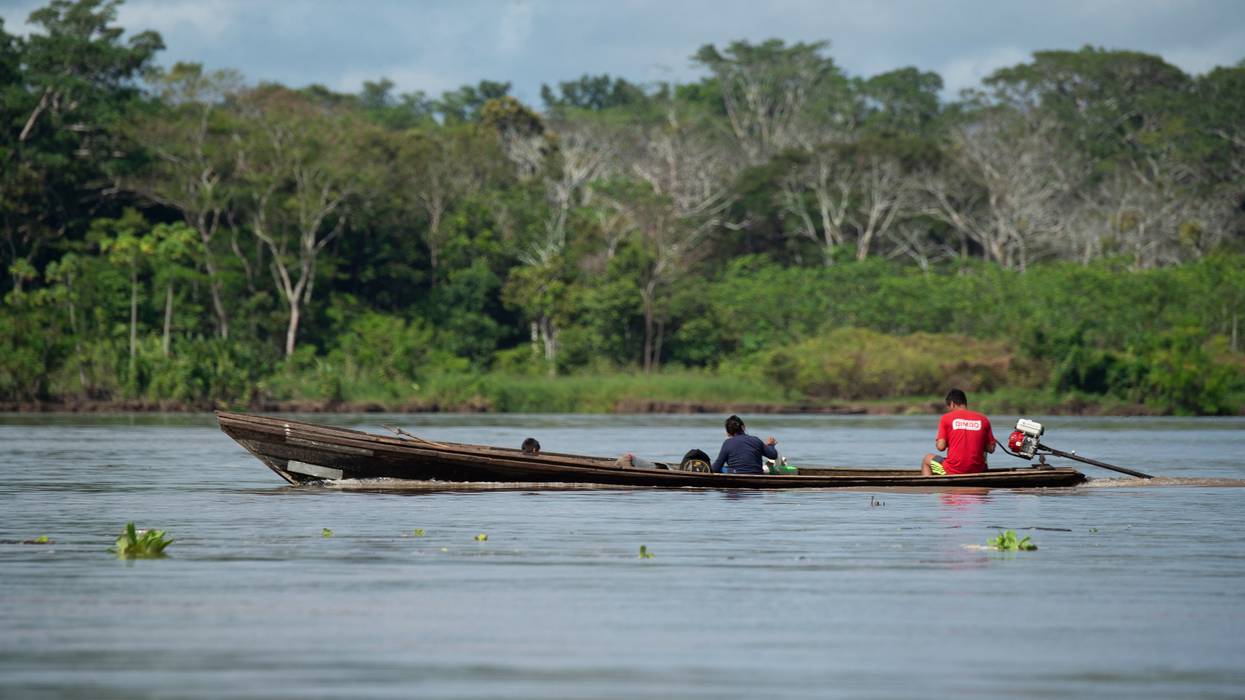 Locals ride a boat on the Marañón River