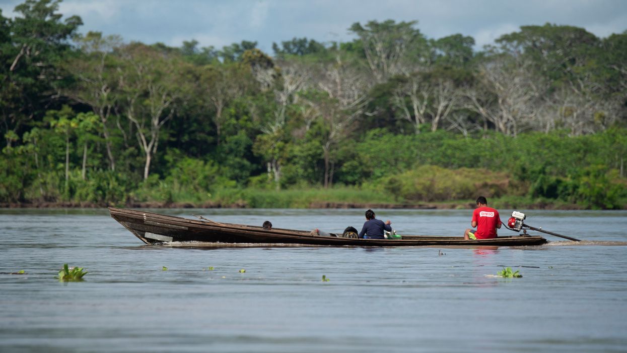 Locals ride a boat on the Marañón River