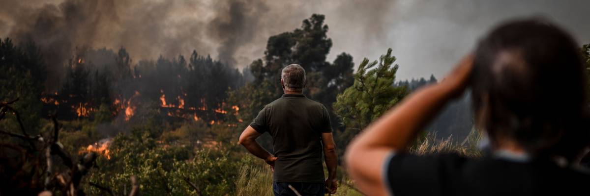 Locals watch the advance of a wildfire in Orjais, Covilha council in central Portugal