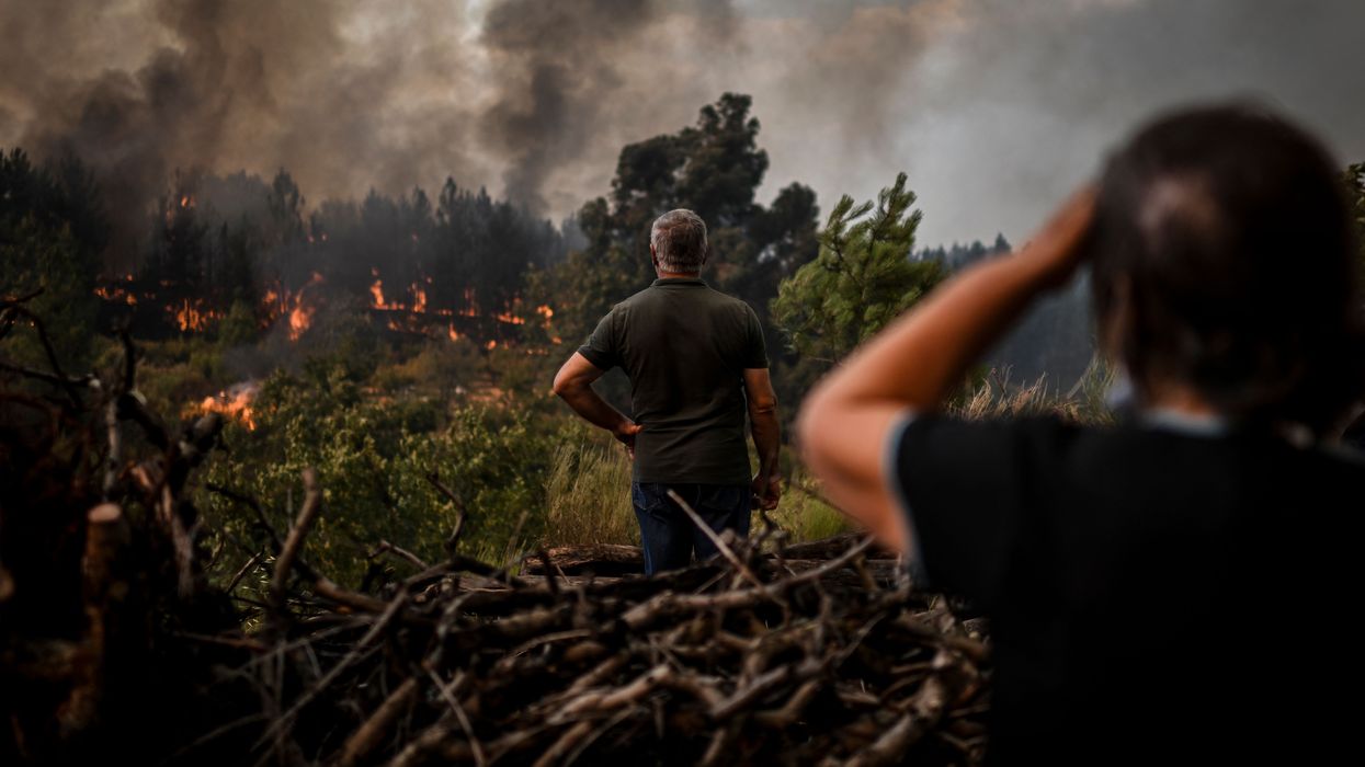 Locals watch the advance of a wildfire in Orjais, Covilha council in central Portugal