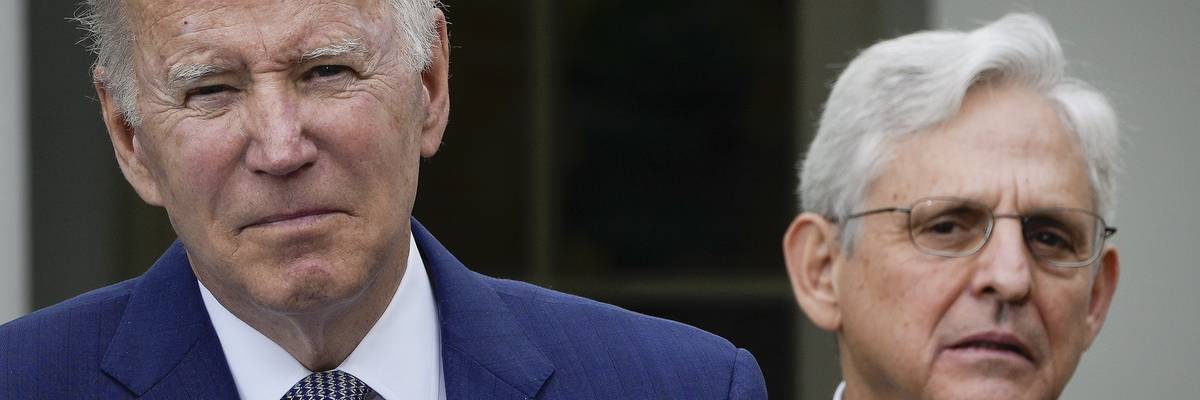 looks on as U.S. President Joe Biden