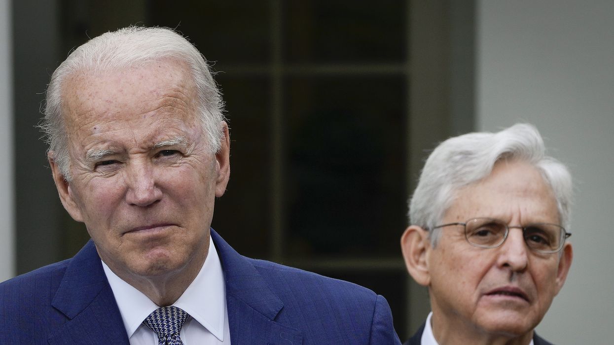 looks on as U.S. President Joe Biden