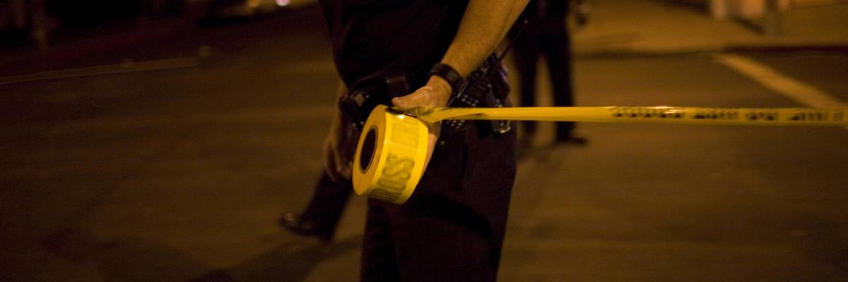 Los Angeles Police Department officers tape off a Crime Scene Investigation area