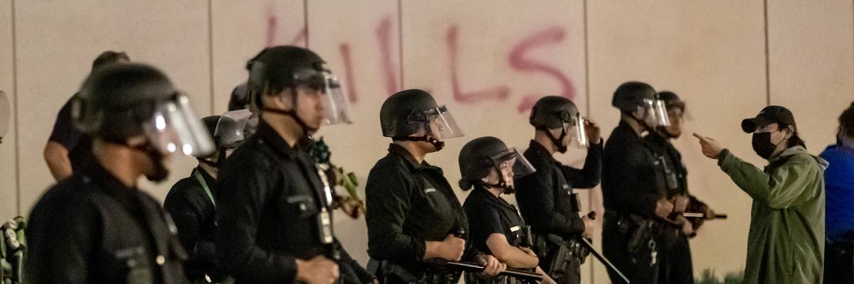 Los Angeles Police officers stand should to shoulder