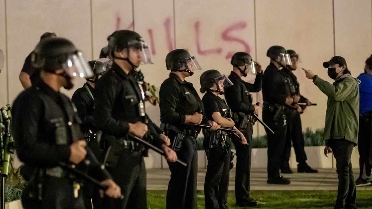 Los Angeles Police officers stand should to shoulder