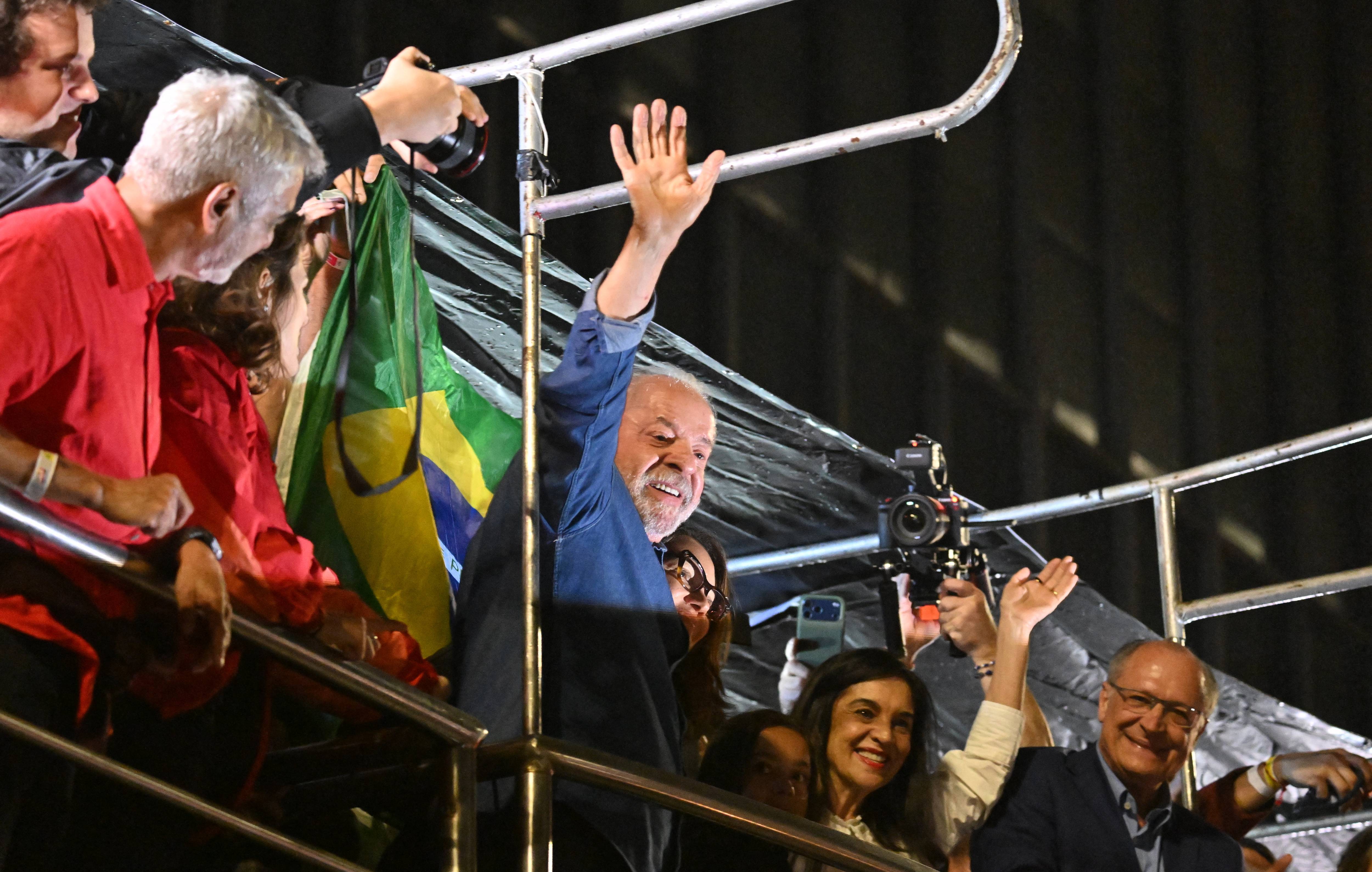 Lula waves to supporters after winning reelection