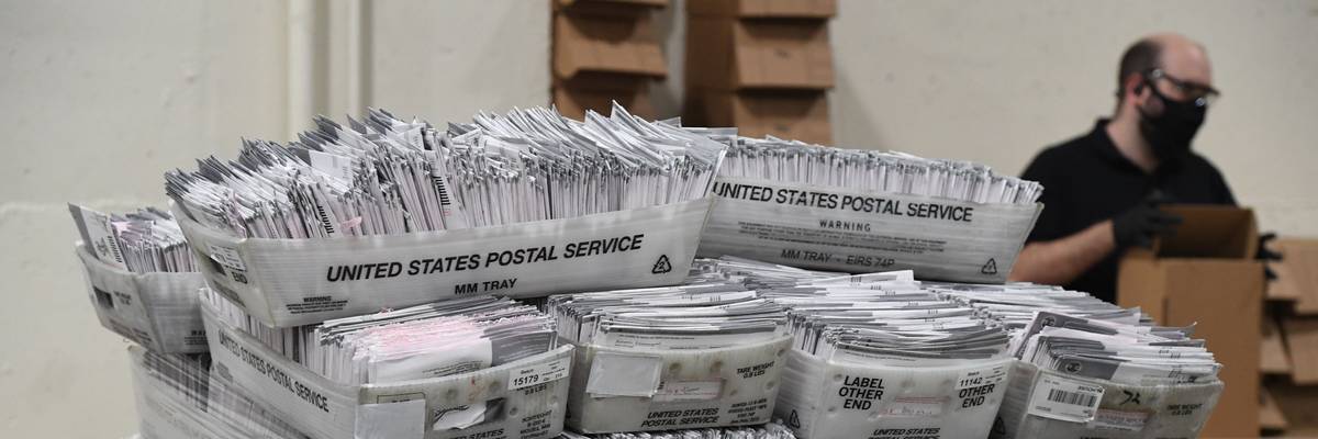 Mail-in ballots in boxes.