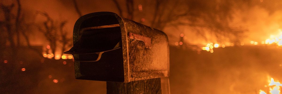 Mailbox standing as the fires burn