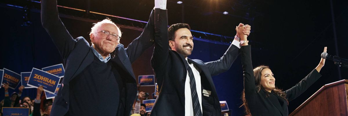 Mamdani holds hands up high with Bernie Sanders on one side and AOC on the other