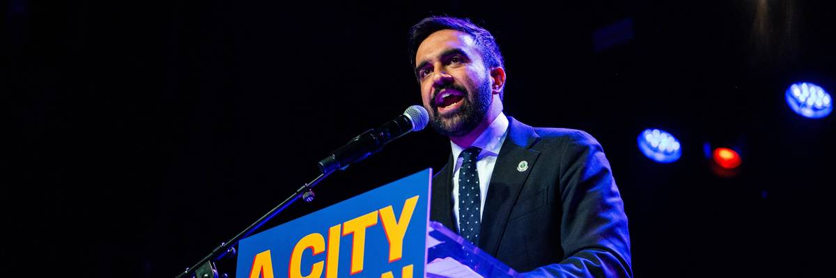 Mamdani speaks at a podium that has a sign that says "a city we can afford."