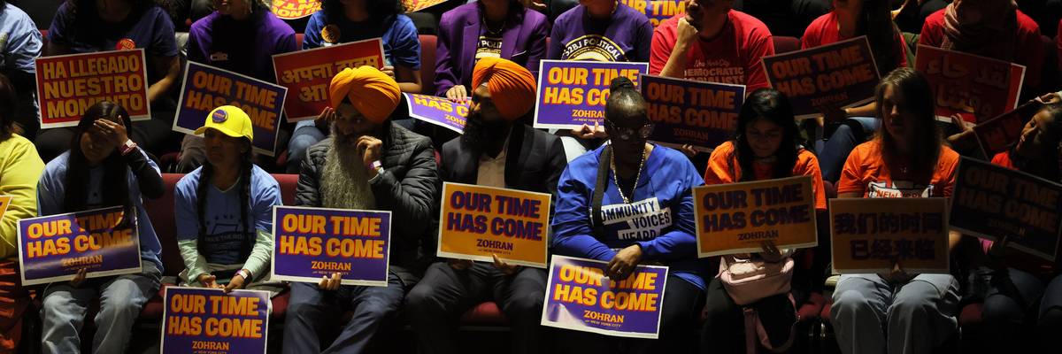 Mamdani supporters hold signs reading, "Our time has come."