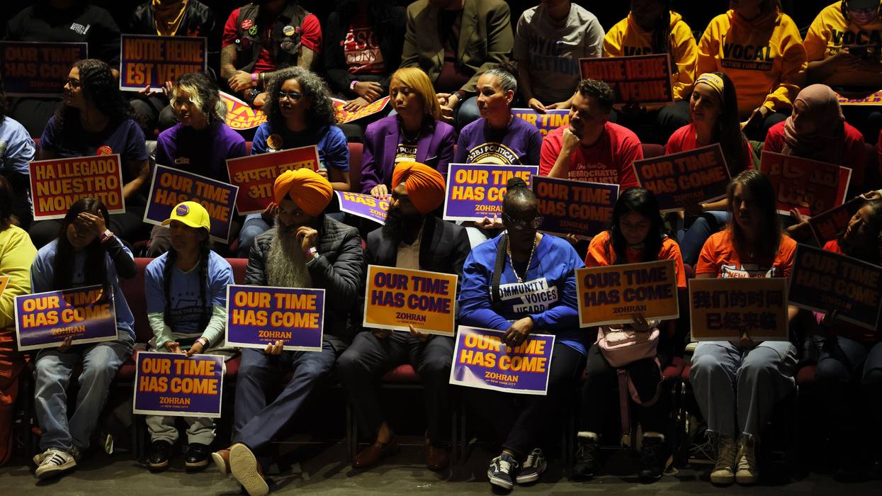 Mamdani supporters hold signs reading, "Our time has come."