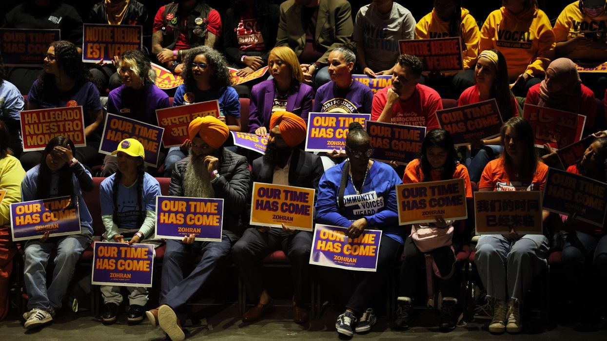 Mamdani supporters hold signs reading, "Our time has come."