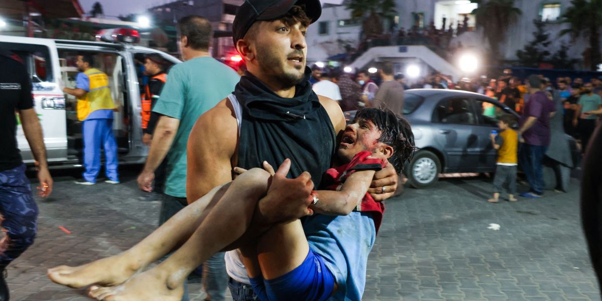 man-carries-a-child-wounded-by-israeli-airstrikes.jpg