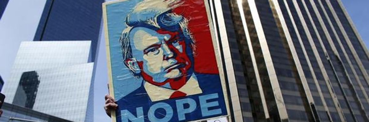 Man holds a NOPE to Trump sign