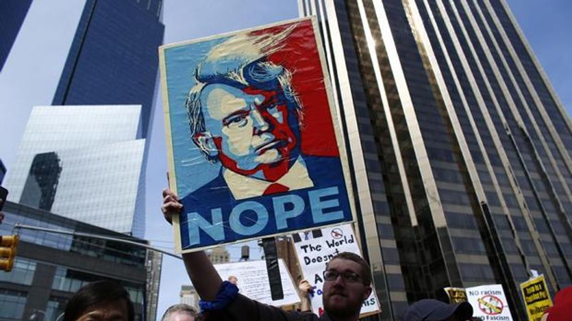 Man holds a NOPE to Trump sign