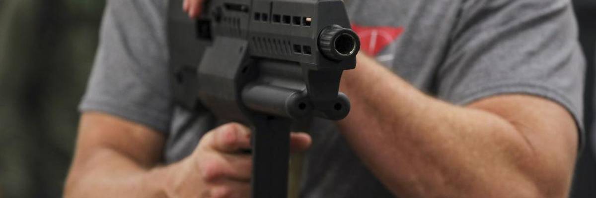 Man holds assault weapon at Nation's Gun Show in Virginia