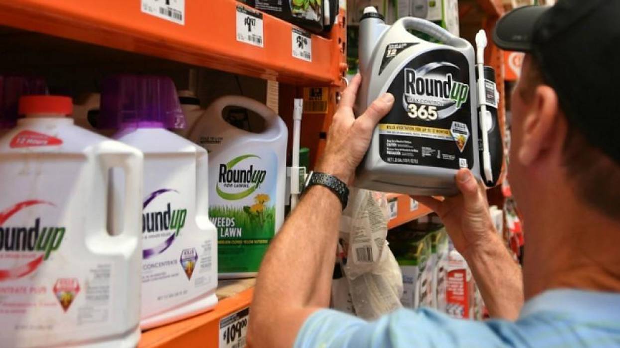 Man holds glyphosate bottle