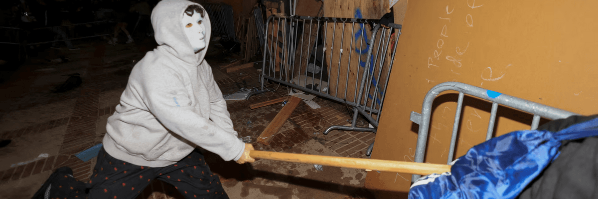 man in mask wielding wooden stick