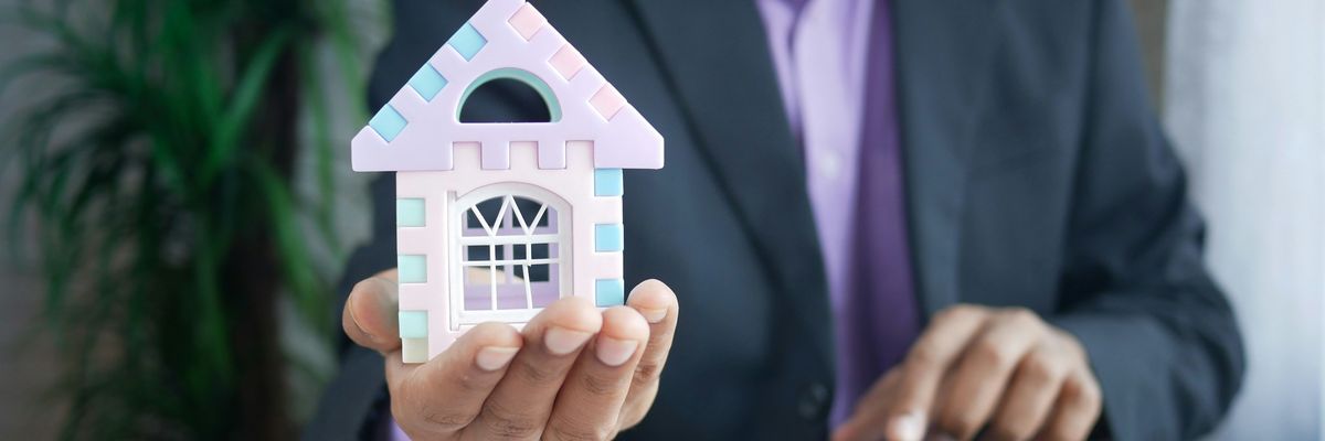 man in purple suit jacket using laptop computer