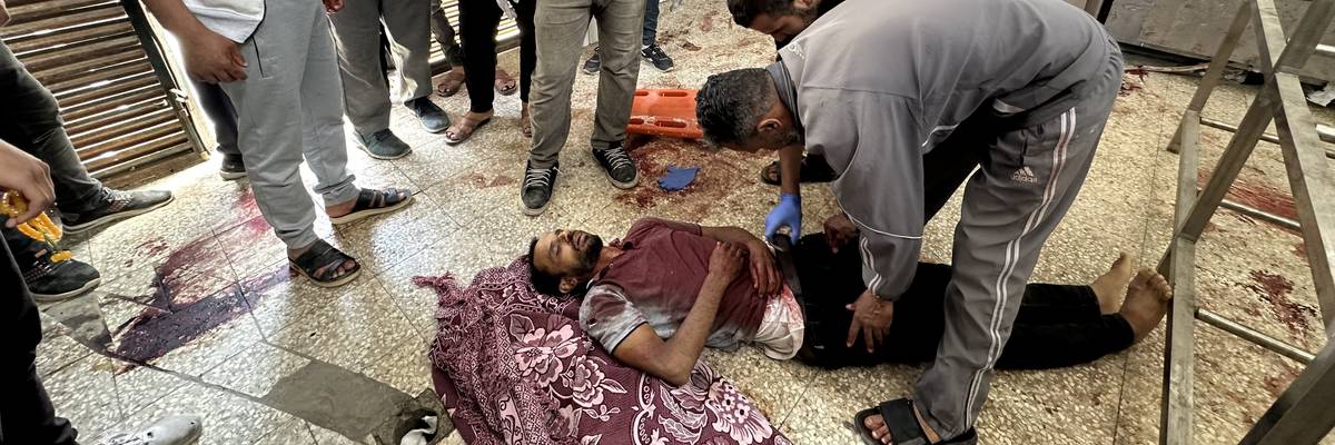 Man killed in Israel attack in Gaza lies on hospital floor.