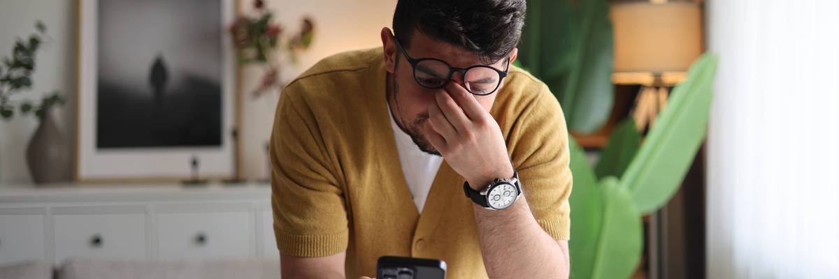 Man looks annoyed while holding phone
