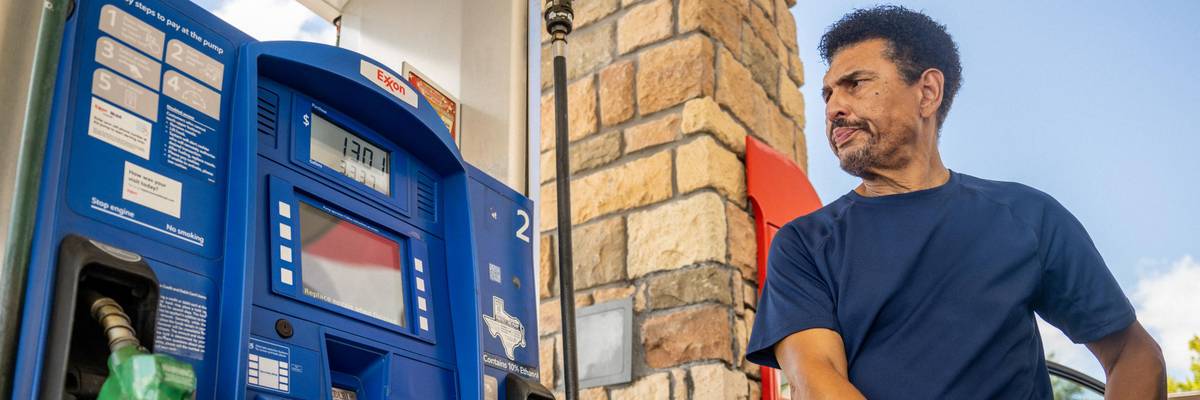 Man pumps gas at Exxon station