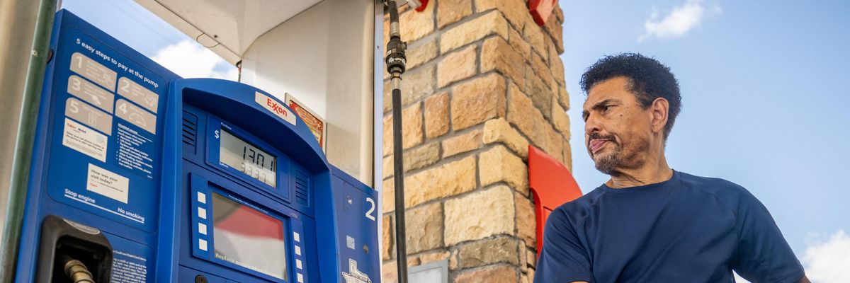 Man pumps gas at Exxon station