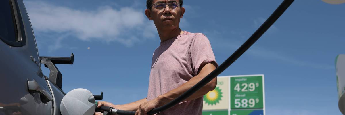 man puts fuel in his vehicle in florida